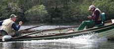 Two men fishing on a lake in a boat