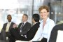 Business woman smiling with group in background