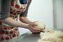 baker's hands kneading dough