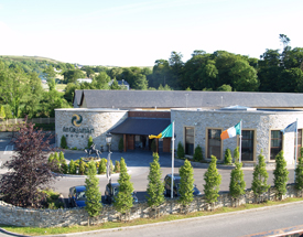 An Grianán Hotel is widely regarded as a gem of Irish hospitality. Trees and flags at the front entrance of the Grianán Hotel