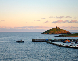 Explore the lighthouse at the Ballycotton Island summit. Ocean and island view from ballycotton harbour