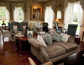 Enjoy rich surroundingsand extensive renovations at Ballyseede Castle. Rich couches and paintings in the Balleyseede Castle lounge area