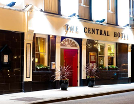 Enjoy your stay in Donegal at the three-star Central Hotel. Front entrance of The Central Hotel with a red door and plants