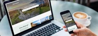 A laptop and a phone with the DiscoverIreland.com listing page